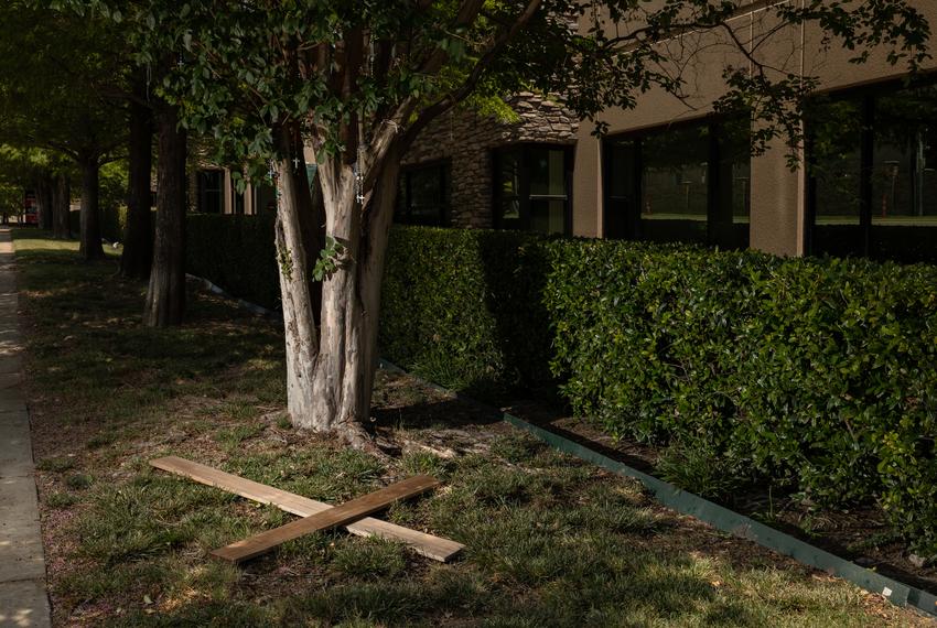 A cross lays on the ground next to a tree dressed in rosaries outside of the Southwestern Women’s Surgery Clinic in Dallas, TX on June 24, 2022.